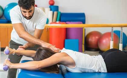 physical therapist working with client on exercises